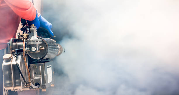 A man use fumigation mosquitoes machine for kill mosquito carrier of Zika virus and dengue fever prevention outbreak in school at the rainy season.Soft and blur focus.